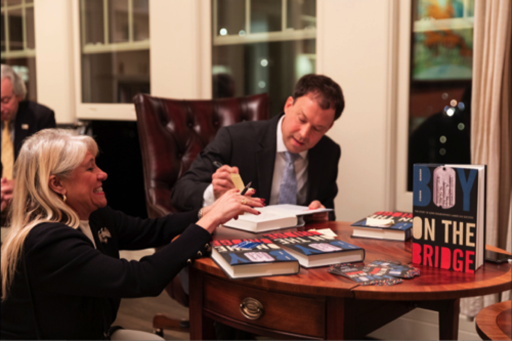 Andrew Marble signing books for Hawkeye Group Intl. president & CEO Eileen Parise.